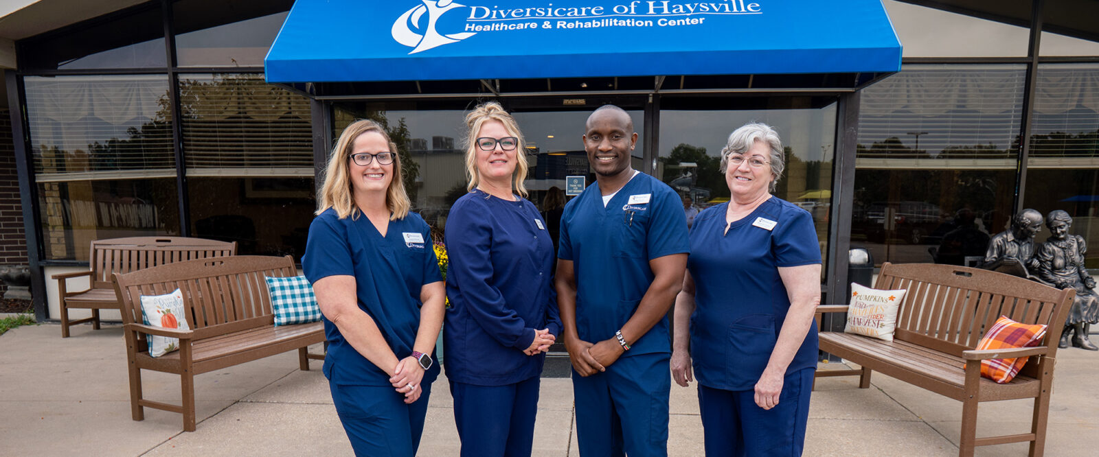 Healthcare professionals in scrubs outside a rehabilitation center.