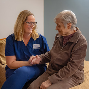 Caregiver and senior woman sharing a moment together.